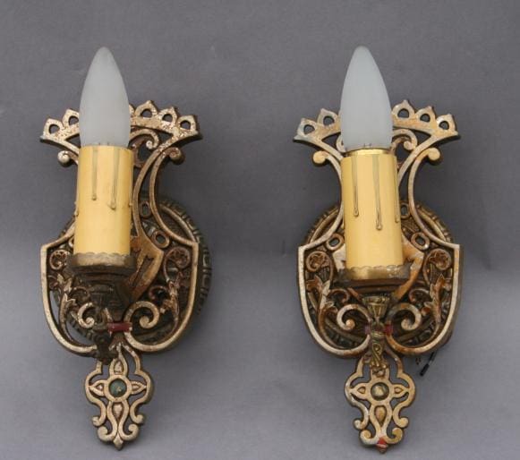 Ornate wall sconces with curved design.
