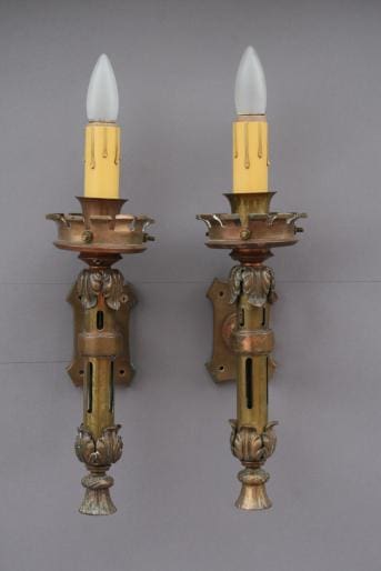 Two vintage wall sconces with candle bulbs.