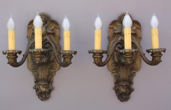 Antique wall sconces with candle-like bulbs.