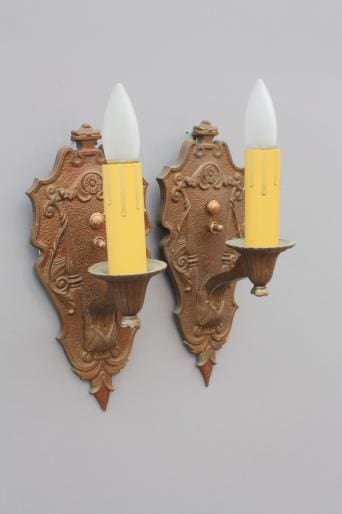 Vintage wall sconces with yellow candles.