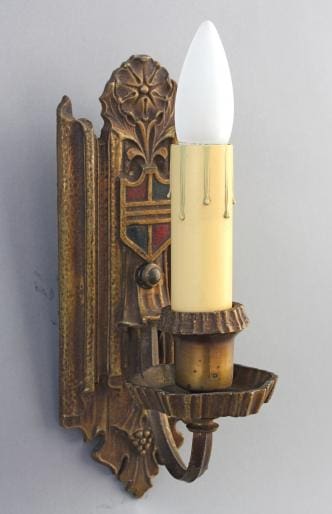 Antique wall sconce with candle-like bulb.