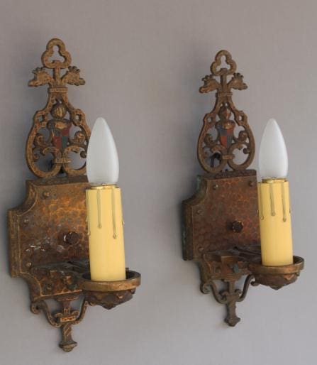 Ornate wall sconces with candle-like lights.