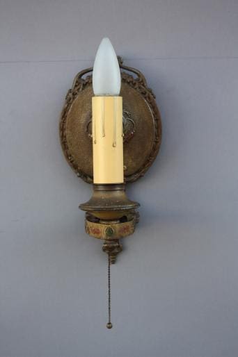Vintage wall sconce with candlelight design.