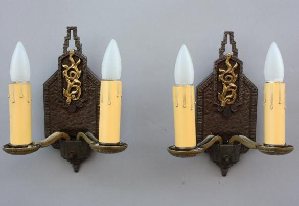 Antique wall sconces with candle-like bulbs.