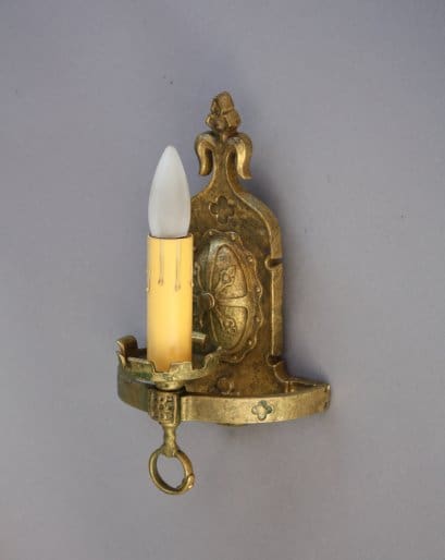 Vintage brass wall sconce with candle.