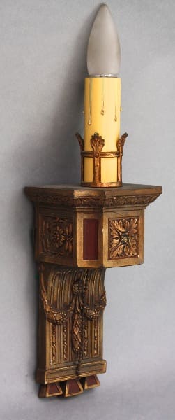 Decorative wall sconce with candle-style light.