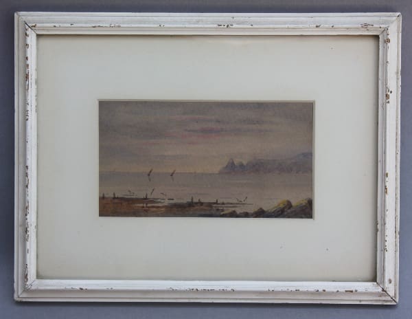 Coastal landscape painting in ornate frame.