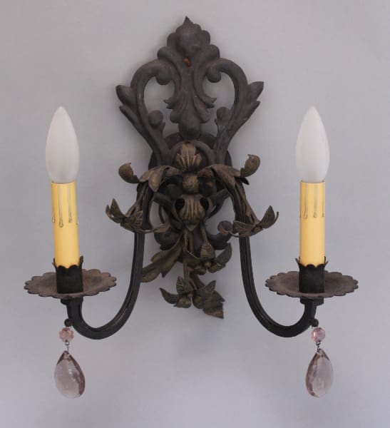 Ornate wall sconce with two candle holders.