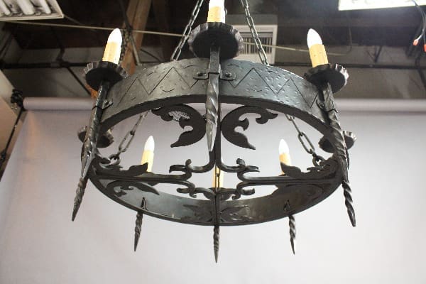 Wrought iron chandelier with candle-shaped lights.