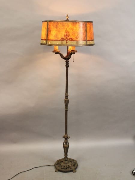 Antique floor lamp with ornate lampshade.