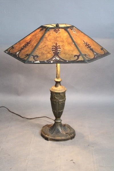 Antique table lamp with decorative lampshade.