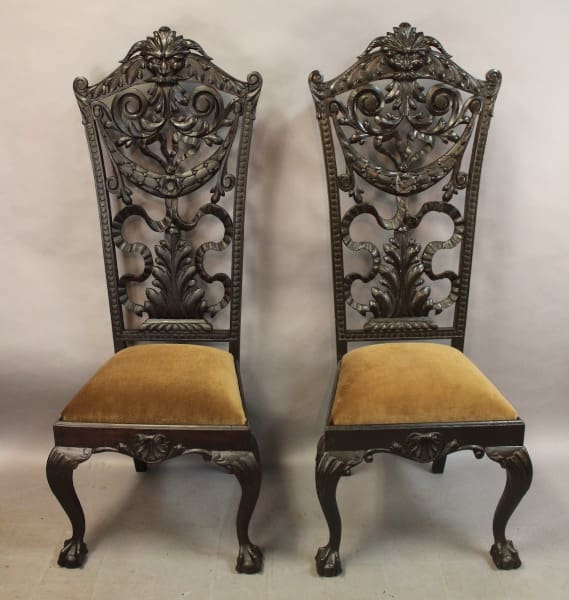 Two ornate wooden chairs with cushioned seats.