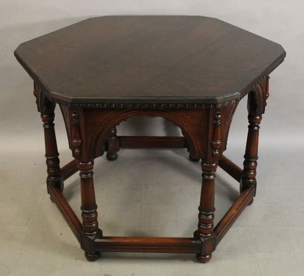 Octagonal wooden table with carved legs.