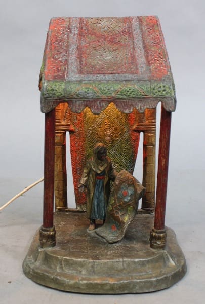 Antique figurine lamp with colorful canopy.
