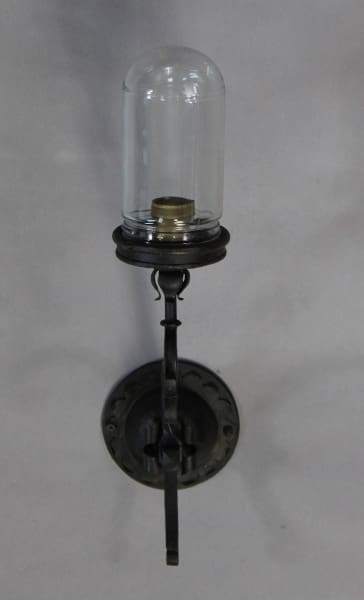 Vintage wall-mounted metal and glass sconce.