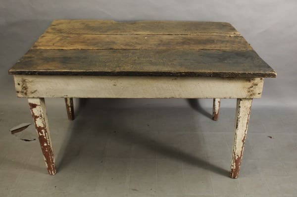 Old rustic wooden table with peeling paint.