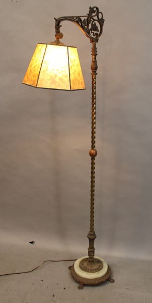 Vintage brass floor lamp with yellow shade.
