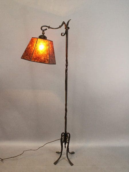 Ornate floor lamp with glowing orange shade.
