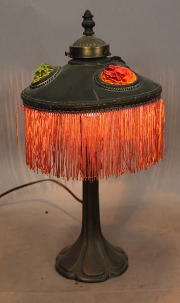 Vintage lamp with fringe and ornate details.