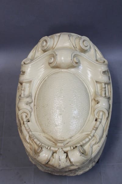 Ornate white ceramic decorative wall ornament.