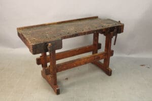 Vintage wooden workbench with vise attached.