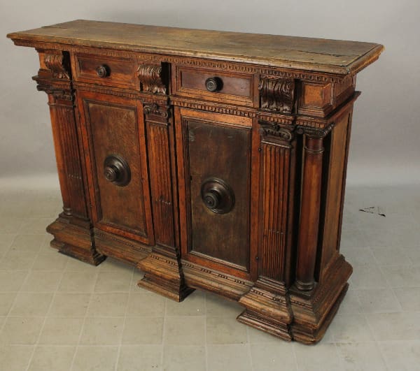 Antique wooden sideboard with ornate carvings.