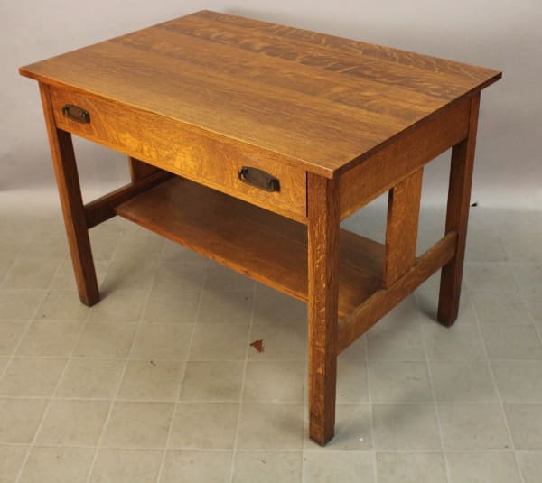 Wooden table with drawer and shelf.