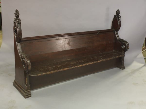 Ornate wooden church pew with carvings.