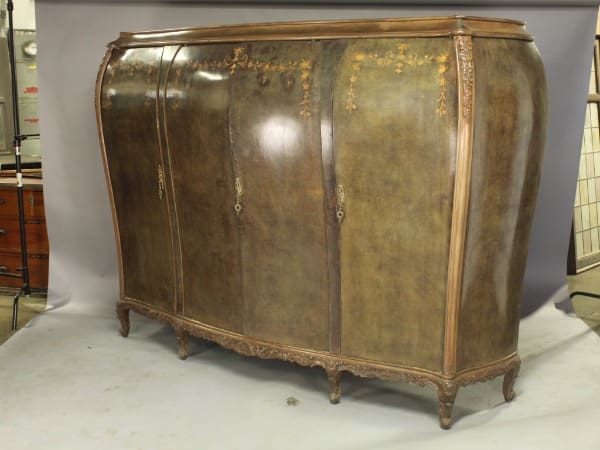 Antique wooden armoire with ornate detailing.