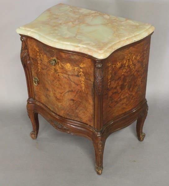 Antique wooden nightstand with marble top.
