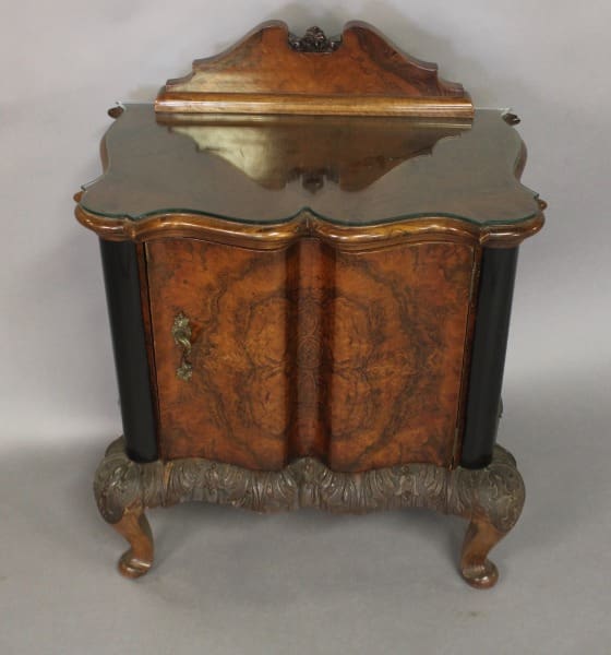 Ornate wooden cabinet with decorative carvings.