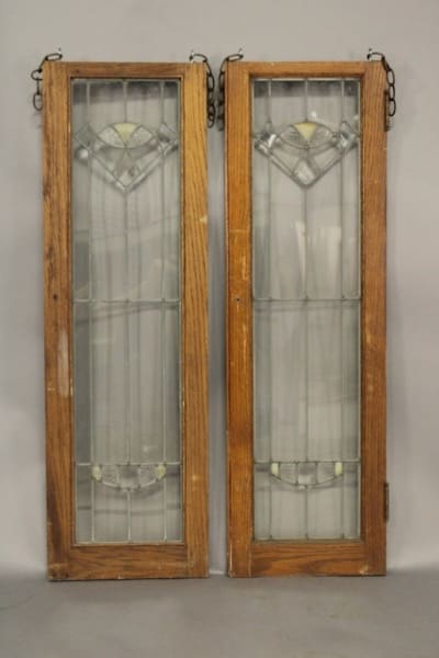 Two wooden framed stained glass windows.