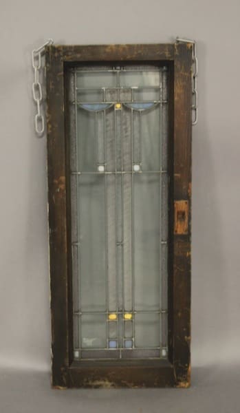Stained glass panel in wooden frame.