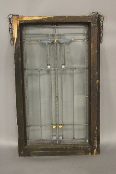 Antique stained glass window with metal frame.