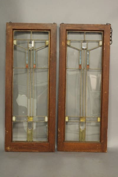 Two wooden framed stained glass windows.