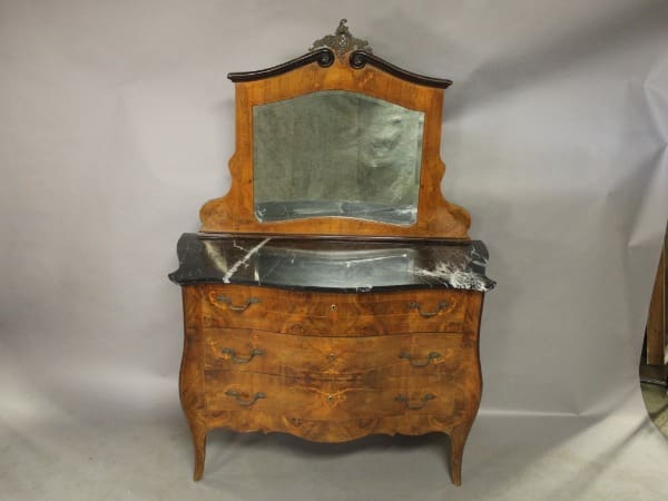 Ornate wooden dresser with mirror and drawers.