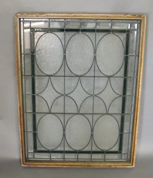 Vintage stained glass window with oval patterns.
