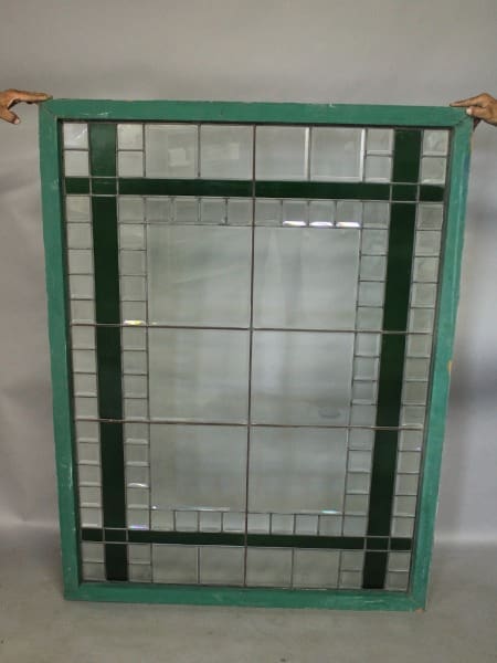 Green-framed stained glass window panel.