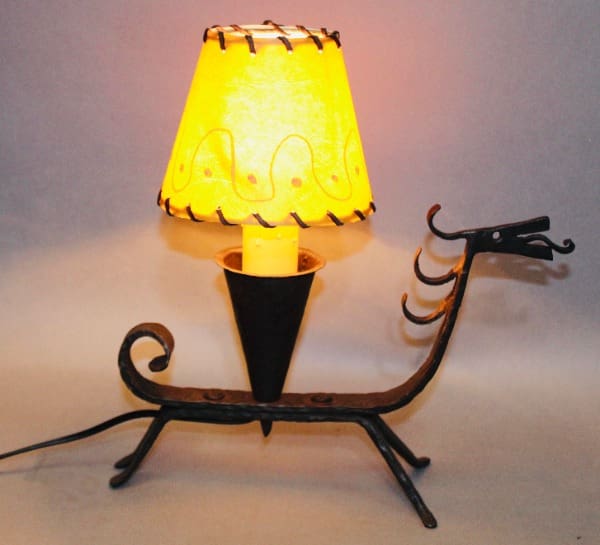 Dragon-shaped lamp with a glowing shade.