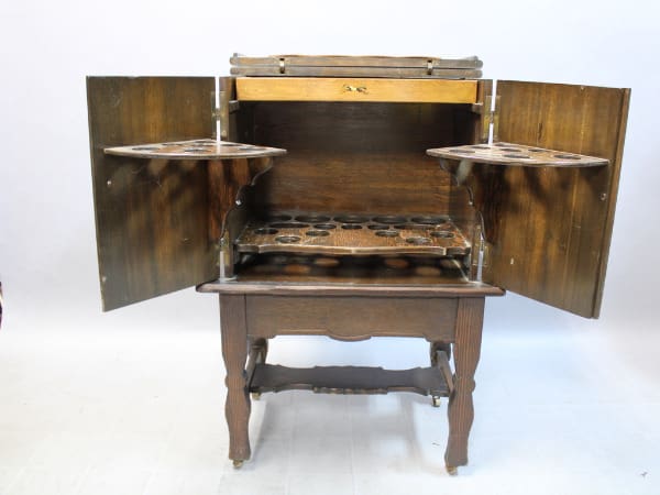 Vintage wooden phonograph cabinet with open doors.