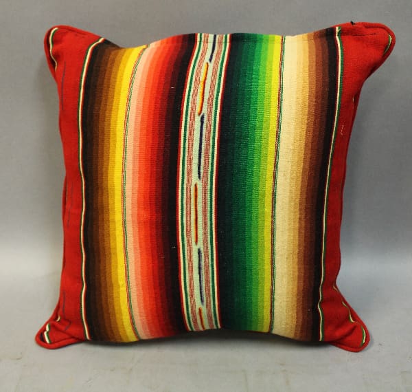 Colorful striped pillow with red edges.