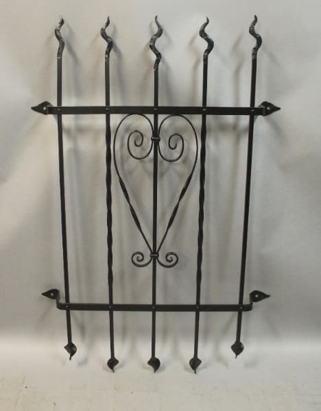 Decorative wrought iron fence panel with heart.