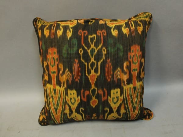 Colorful patterned pillow with tribal design.