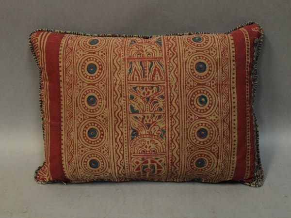 Decorative pillow with intricate geometric patterns.