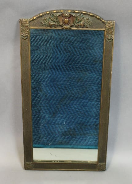 Ornate rectangular mirror with decorative frame.