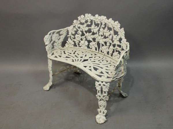 White ornate cast iron garden bench.