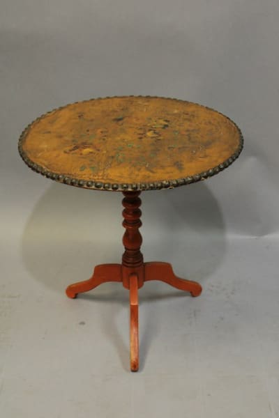 Antique round wooden table with pedestal base.
