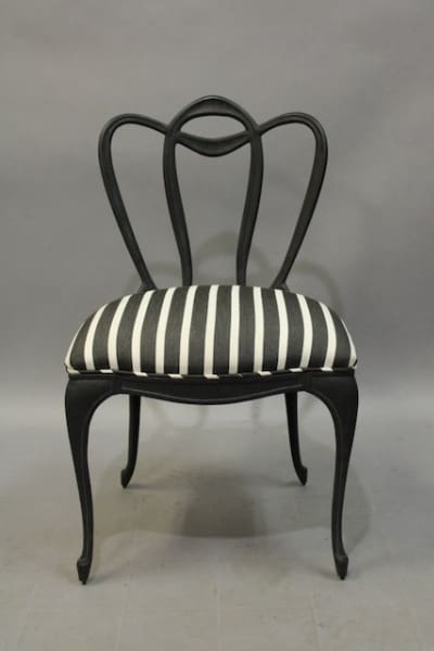Black chair with striped seat cushion.