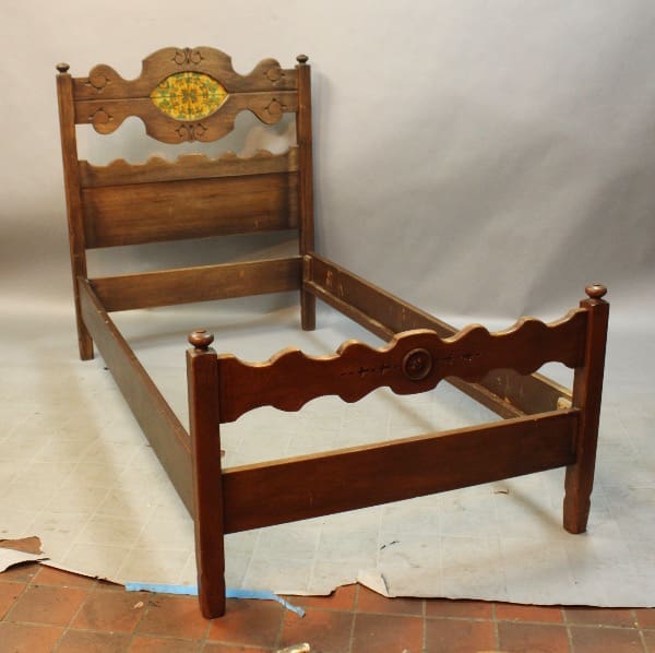 Antique wooden bed frame with carved details.