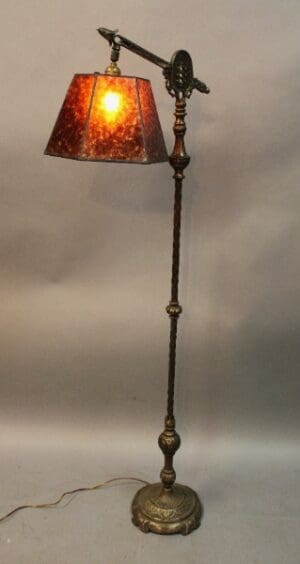 Vintage floor lamp with ornate red shade.